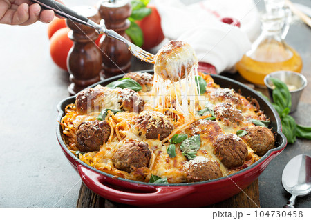 Baked meatballs with spaghetti and cheese Baked meatballs with spaghetti and cheese 104730458
