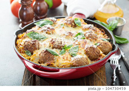 Baked meatballs with spaghetti and cheese 104730459