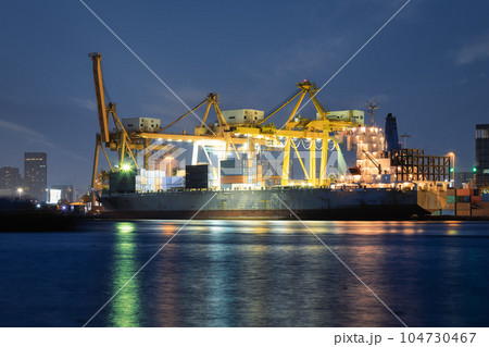 Cargo ship at dock with sky background. Cargo ship at dock with sky background. 104730467