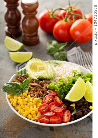 Mexican salad bowl with rice and pulled pork 104730558