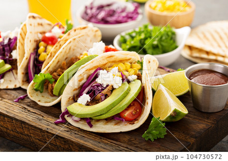 Pulled pork tacos with red cabbage and avocados 104730572