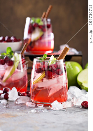 Cold winter cocktail with cranberry and apple Cold winter cocktail with cranberry and apple 104730713