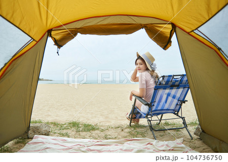 beautiful woman relaxing on the beach in a tent. A beautiful woman relaxing on the beach 104736750