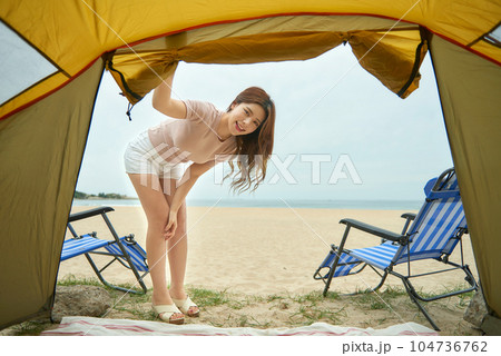 beautiful woman relaxing in a tent on the beach. 104736762