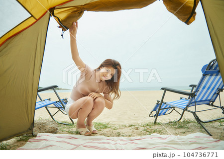 beautiful woman relaxing in a tent on the beach. 104736771