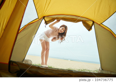 beautiful woman relaxing in a tent on the beach. 104736775