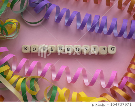 Rosenmontag in wooden cubes on pink background Rosenmontag in wooden cubes on pink background 104737971