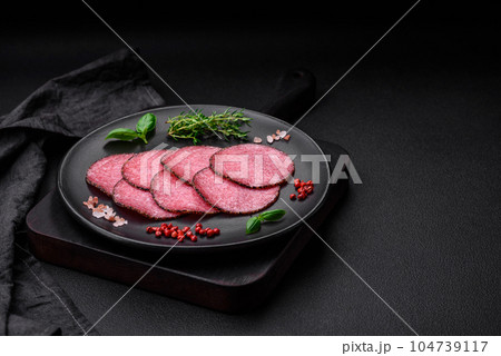 Delicious smoked salami sausage with salt, pepper, spices and herbs 104739117