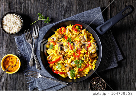 Chicken Paella with mushrooms, red pepper, spices 104739558