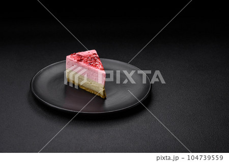 Delicious sweet dessert cheesecake with raspberry and pistachio flavor 104739559