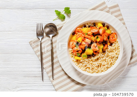 shrimps with beans, mango, brown rice in bowl shrimps with beans, mango, brown rice in bowl 104739570