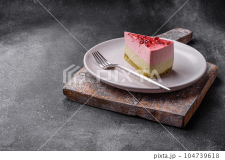 Delicious sweet dessert cheesecake with raspberry and pistachio flavor 104739618
