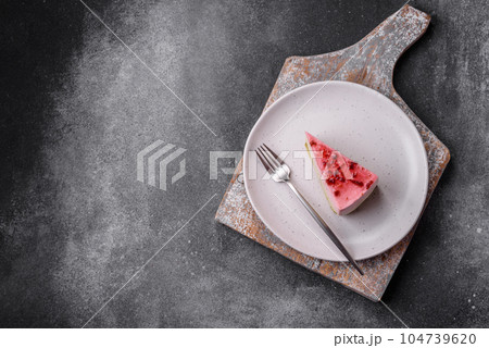 Delicious sweet dessert cheesecake with raspberry and pistachio flavor Delicious sweet dessert cheesecake with raspberry and pistachio flavor 104739620