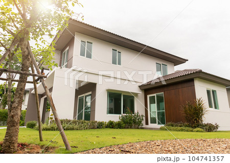 Beautiful modern house exterior with green grass Beautiful modern house exterior with green grass 104741357