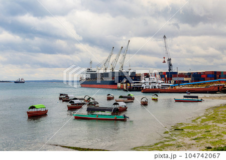 Port of Zanzibar with big ships, cranes and cargos near the quay in Stone Town, Zanzibar, Tanzania Port of Zanzibar with big ships, cranes and cargos near the quay in Stone Town, Zanzibar, Tanzania 104742067