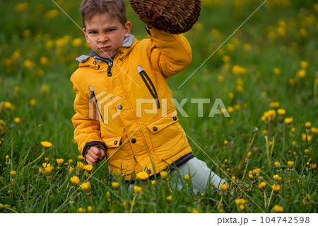 An angry child on a summer field. Children's emotions. An angry child on a summer field. Children's emotions. 104742598