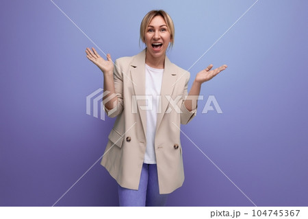 joyful blond business woman in office jacket on studio background joyful blond business woman in office jacket on studio background 104745367