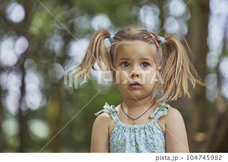 Adorable surprised child in the garden in Denmark 104745982