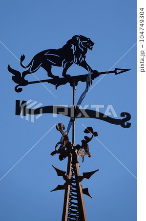 Kiev, Ukraine October 26, 2021: weather vane "Lion" on the spire of the film studio "Victoria film" Ukraine Kiev, Ukraine October 26, 2021: weather vane "Lion" on the spire of the film studio "Victoria film" Ukraine 104749304