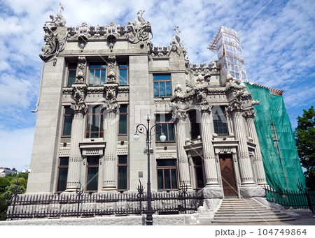 Kiev, Ukraine June 10, 2021: The facade of the building "House with Chimeras" its architectural decoration with sculptures and sculptures of animals and demons 104749864