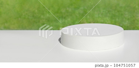 Podium for presentation. Blurred green grass background. Abstract geometrical form. Cylinder stone sphere. Shadow. Scene to show products. Showcase, display case. Trendy sunlight. Front view. 3D Podium for presentation. Blurred green grass background. Abstract geometrical form. Cylinder stone sphere. Shadow. Scene to show products. Showcase, display case. Trendy sunlight. Front view. 3D 104751057