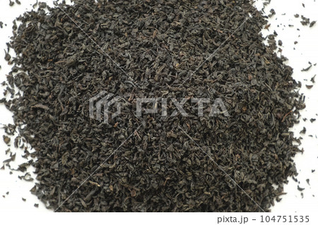 Pile of Black dry Tea on White. Black Tea Leaves. Close Up, Macro. Top View. Texture. Full Frame. Copy Space. Dried Tea. Abstract Food and Drink Background 104751535