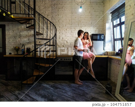 Young couple hugging on Valentine's Day morning in the kitchen Young couple hugging on Valentine's Day morning in the kitchen 104751857