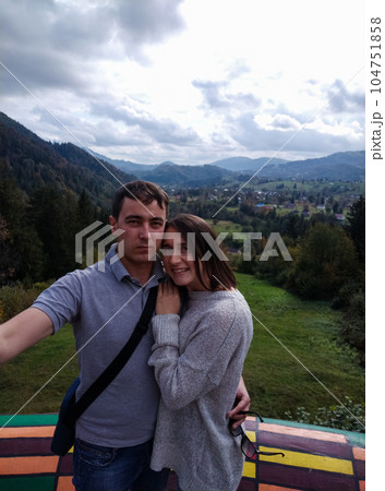 couple of travelers making selfie with mountain view couple of travelers making selfie with mountain view 104751858