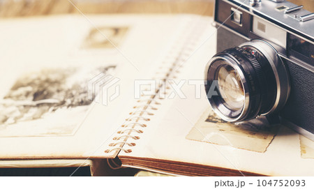 retro camera on the background of old photos retro camera on the background of old photos 104752093