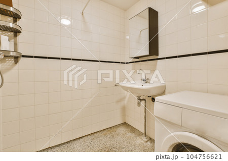 a laundry room with a washer and dryer in the corner on the right hand side of the photo a laundry room with a washer and dryer in the corner on the right hand side of the photo 104756621