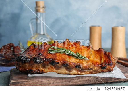Tasty grilled ribs with rosemary on table 104756977