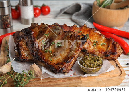 Tasty aromatic grilled ribs with thyme served on table 104756981