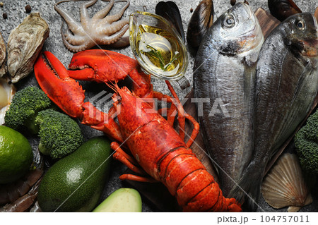 Fresh fish and different seafood on grey table, top view 104757011