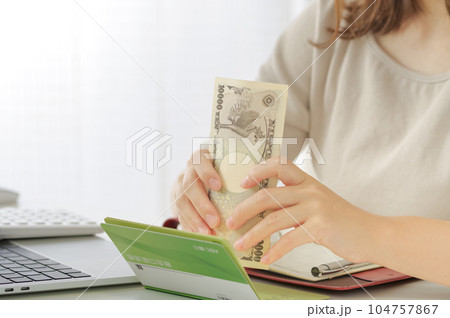 お金の計算をする若い女性 104757867