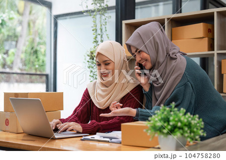 Muslim two woman freelancer sme business online shopping working on laptop computer and checklist order box at home Business online shipping and delivery concept Muslim two woman freelancer sme business online shopping working on laptop computer and checklist order box at home Business online shipping and delivery concept 104758280
