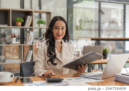 Accountant or business woman working Financial investment on calculator, calculate, analyze business and marketing growth on financial document data graph Accountant or business woman working Financial investment on calculator, calculate, analyze business and marketing growth on financial document data graph 104758409