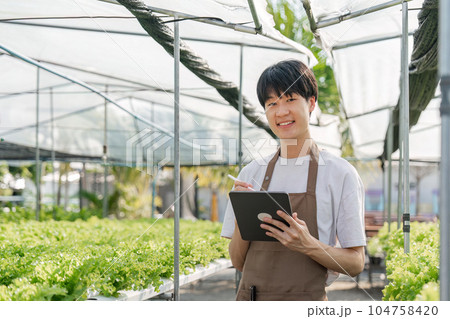Farmer plantation checking quality by tablet agriculture modern technology Concept. Smart farming, using modern technologies in agriculture Farmer plantation checking quality by tablet agriculture modern technology Concept. Smart farming, using modern technologies in agriculture 104758420