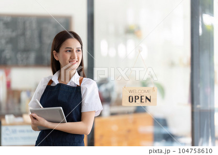Startup successful small business owner sme beauty girl stand with tablet in coffee shop restaurant. Portrait of asian woman barista cafe owner. SME entrepreneur seller business concept 104758610