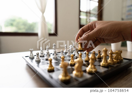 businessman hand moving gold Chess King figure and Checkmate opponent during chessboard competition. Strategy, Success, management, business planning, disruption and leadership concept businessman hand moving gold Chess King figure and Checkmate opponent during chessboard competition. Strategy, Success, management, business planning, disruption and leadership concept 104758654