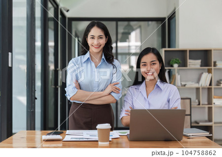 Two business workers smiling happy at the office 104758862
