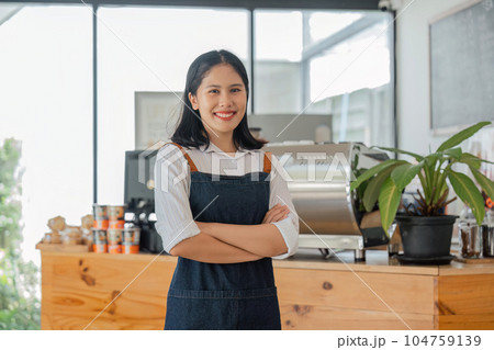 Asian woman coffee shop employee barista working at cafe. Smiling female waitress cashier. Small business owner and part time job working concept Asian woman coffee shop employee barista working at cafe. Smiling female waitress cashier. Small business owner and part time job working concept 104759139