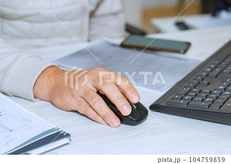 Organized desktop of businessman reflects his meticulous approach to his work on computer. 104759859