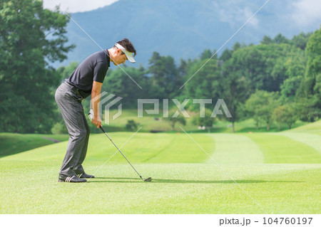 ゴルフ場でアイアンショットをするゴルファーの男性 ゴルフ場でアイアンショットをするゴルファーの男性 104760197