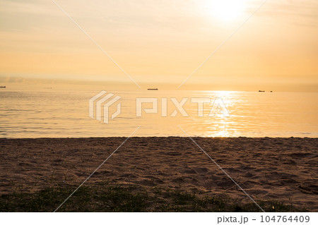 Light Evening on Coast Sand Beach Sea Ocean, Sunset Background,Dramatic Twilight Golden Nature Landscape,Horizon Backdrop,Card Poster for Tropical Travel Summer Holidays,Autumn,Broken Heart,Valentine. Light Evening on Coast Sand Beach Sea Ocean, Sunset Background,Dramatic Twilight Golden Nature Landscape,Horizon Backdrop,Card Poster for Tropical Travel Summer Holidays,Autumn,Broken Heart,Valentine. 104764409