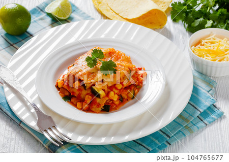 enchilada casserole with veggies, corn, pinto bean 104765677