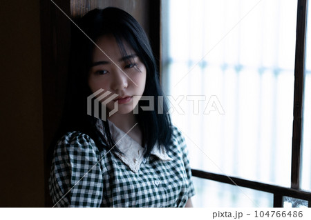 昭和レトロな部屋でくつろぐアンニュイな雰囲気の若い女性 昭和レトロな部屋でくつろぐアンニュイな雰囲気の若い女性 104766486
