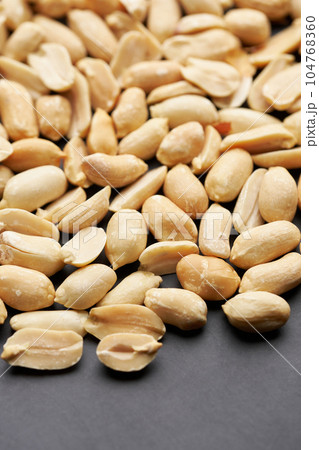Whole shelled peanut nuts kernels close-up studio background Whole shelled peanut nuts kernels close-up studio background 104768360