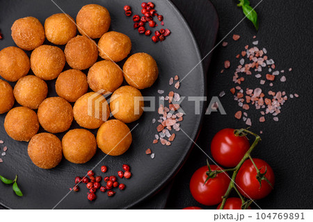 Delicious fried potato balls with breaded mozzarella, salt, spices and herbs Delicious fried potato balls with breaded mozzarella, salt, spices and herbs 104769891