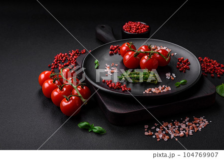 Ingredients for cooking cherry tomatoes, salt, spices and herbs Ingredients for cooking cherry tomatoes, salt, spices and herbs 104769907