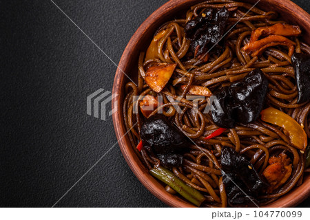 Delicious fresh buckwheat noodles or udon with mushrooms, peppers and other vegetables 104770099